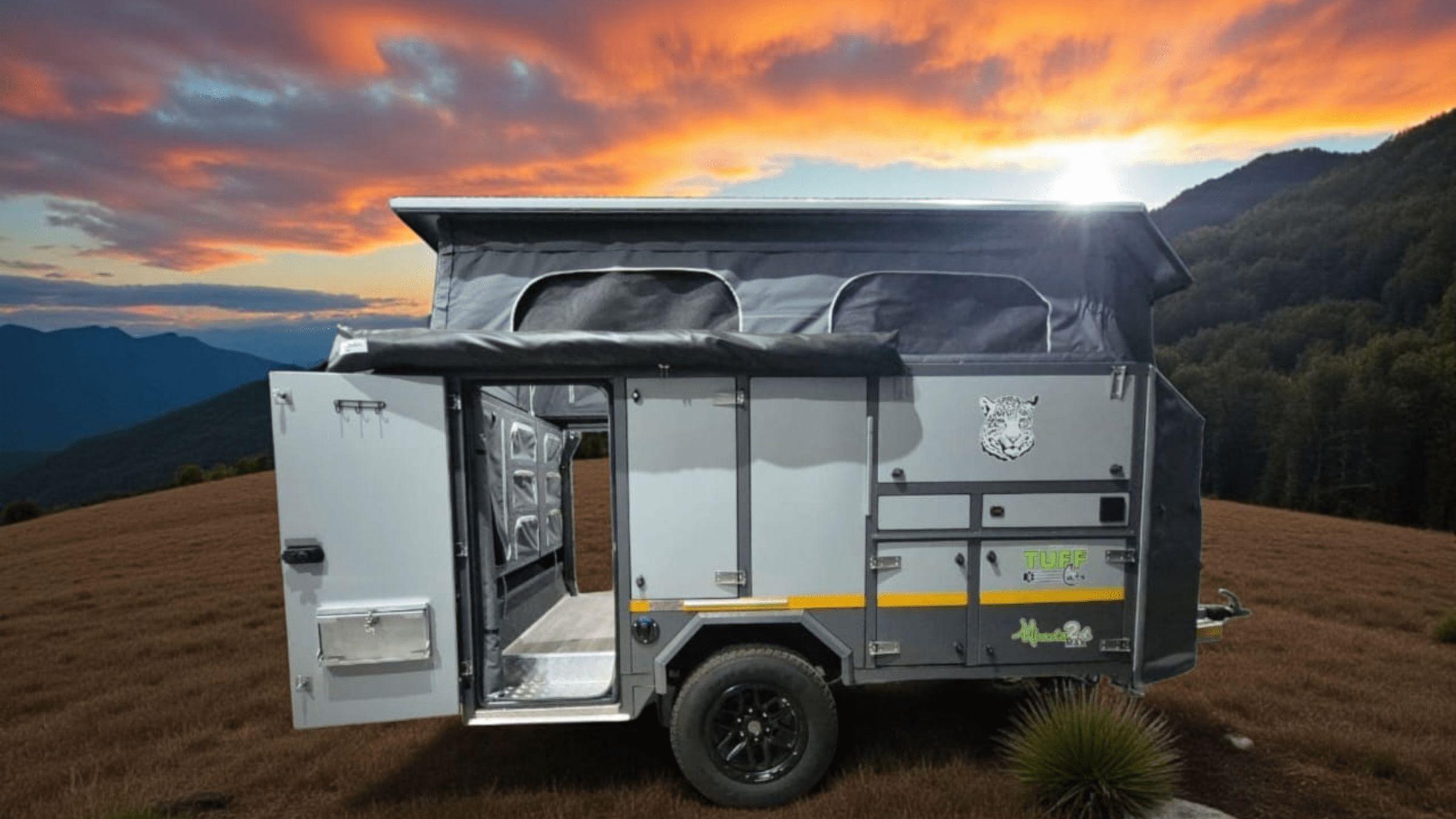 Tuff Cats Mbada 2D Max offroad caravan on a mountain ridge at sunset